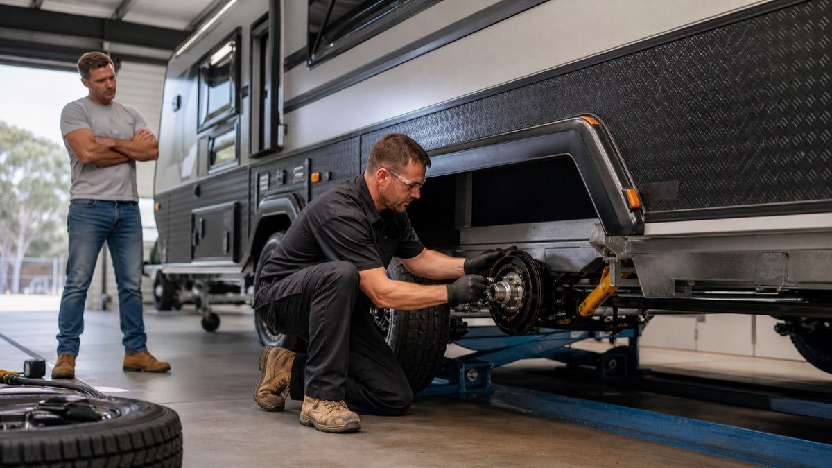 Technician inspecting caravan tyres, wheel bearings and brakes