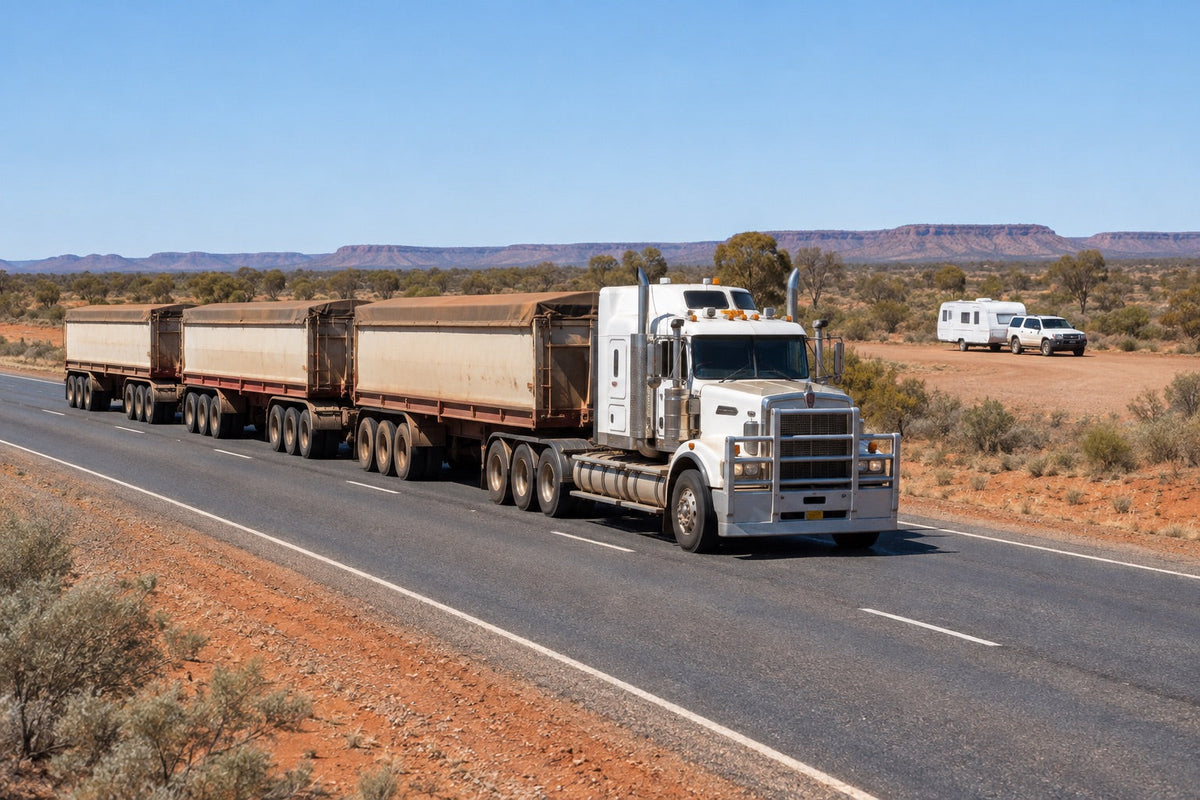 Multi-trailer road train passing a safely parked caravan on an outback highway